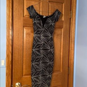 a body con off the shoulder black sparkly dress